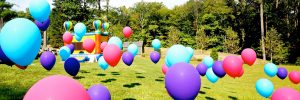 Multi Colored Balloons Floating on Grass